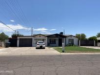 Newly renovated home with a two-car garage and landscaped yard at 2303 W Marshall Ave, Phoenix, AZ 85015