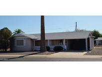 Ranch-style home with gray roof and light-colored exterior at 11427 N 107Th Ave, Sun City, AZ 85351