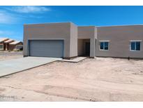 Single-story home with stucco exterior and two-car garage at 15941 S Animas Rd, Arizona City, AZ 85123