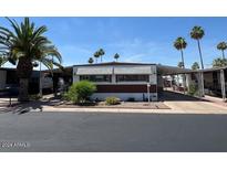 Inviting exterior of a single-story home with landscaped yard at 9501 E Broadway Rd # 221, Mesa, AZ 85208