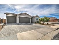 Two-story home with a two-car garage and paver driveway at 1859 N Westfall Ln, Casa Grande, AZ 85122