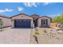 Modern house exterior with brick accents and a two-car garage at 347 E Bracciano Ave, Queen Creek, AZ 85140