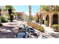 Inviting community walkway with lush landscaping and a glimpse of the pool at 16336 E Palisades Blvd # 9, Fountain Hills, AZ 85268