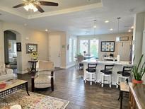 Open concept kitchen and dining area with hardwood floors and breakfast bar at 3301 S Goldfield Rd # 6044, Apache Junction, AZ 85119