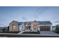 Stunning farmhouse-style home with stone accents and a large garage at 3950 E Penedes Dr, Gilbert, AZ 85298