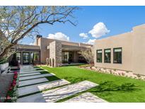 Landscaped backyard featuring a modern home with stone accents at 24046 N 126Th Pl, Scottsdale, AZ 85255