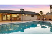 Inviting backyard oasis featuring a sparkling pool and relaxing patio furniture at 3233 S Lebanon Ln, Tempe, AZ 85282
