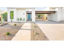 Modern home exterior with blue door and gravel landscaping at 8634 E Monterosa Ave, Scottsdale, AZ 85251