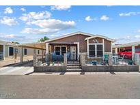Attractive manufactured home with carport and fenced yard at 8865 E Baseline Rd # 128, Mesa, AZ 85209