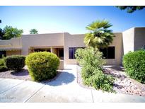 Tan stucco exterior with a walkway and landscaping at 14300 W Bell Rd # 444, Surprise, AZ 85374