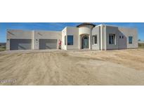 Modern home exterior with a two car garage and desert landscaping at 38718 N 24Th Ave, Phoenix, AZ 85086