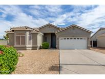 Tan house with a two-car garage and landscaping at 165 E Liberty Ln, Gilbert, AZ 85296