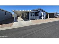 A charming manufactured home with carport and front porch at 650 N Hawes Rd # 3803, Mesa, AZ 85207