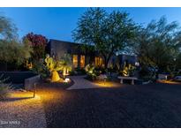 Stunning desert landscape home exterior at night at 5431 E Olesen Rd, Cave Creek, AZ 85331