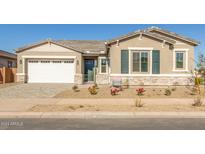 Charming single-story home with a two-car garage and landscaped front yard at 21680 E Roundup Way, Queen Creek, AZ 85142