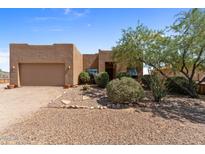 One-story stucco home with a two-car garage and desert landscaping at 48940 W Long Rifle Rd, Aguila, AZ 85320