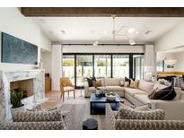 Open living area with a large sectional sofa and a view of the pool at 6044 E Calle Del Paisano --, Scottsdale, AZ 85251