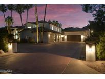 Luxury home with a large driveway at dusk at 9030 N 48Th Pl, Paradise Valley, AZ 85253