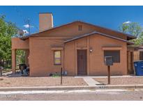 Cute bungalow style home with a brown front door and small front yard at 687 W Navajo St, Wickenburg, AZ 85390