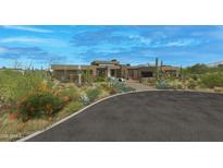 Luxury home with desert landscaping and a large driveway at 10308 E Filaree Ln, Scottsdale, AZ 85262