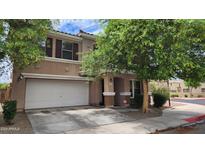 Two story home with attached garage and landscaping in front at 6349 W Valencia Dr, Laveen, AZ 85339