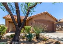 One-story home with desert landscaping and two-car garage at 2514 W Bisbee Way, Anthem, AZ 85086