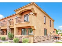 Two-story stucco home with a balcony and stone accents at 21655 N 36Th Ave # 104, Glendale, AZ 85308