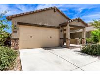 Single-story home with two-car garage and desert landscaping at 40486 W Sunland Dr, Maricopa, AZ 85138