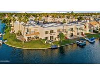 Aerial view of a waterfront property with boat slips and lush landscaping at 1438 W Coral Reef Dr, Gilbert, AZ 85233
