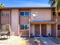 Two-unit building exterior with front yard and grill at 1750 E Mateo Cir # 103, Mesa, AZ 85204