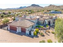 Aerial view of a luxury home with a large yard and mountain views at 9233 S Krista E Dr, Goodyear, AZ 85338