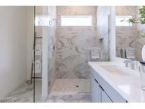 Elegant bathroom featuring a walk-in shower and double sinks at 18047 W Long Lake Rd, Goodyear, AZ 85338