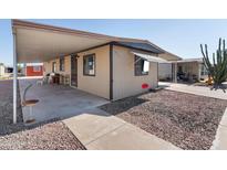 Tan mobile home with covered carport and walkway at 3330 E Main St # 327, Mesa, AZ 85213