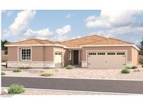 Tan two-story house with a three-car garage at 10512 S 48Th Gln, Laveen, AZ 85339