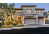 Two-story house with a balcony, wrought iron accents, and a two-car garage at 6545 N 29Th St, Phoenix, AZ 85016