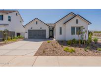 Modern home exterior with gray garage door and landscaped front yard at 35658 N Lodestone Dr, San Tan Valley, AZ 85144