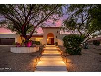 Stunning home exterior with beautifully landscaped entryway at 9020 N 33Rd Way, Phoenix, AZ 85028