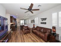 Open living room with hardwood floors and leather furniture at 2673 S Balsam Dr, Gilbert, AZ 85295