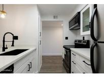 Modern kitchen with white shaker cabinets, stainless steel appliances, and quartz countertops at 7625 E Camelback Rd # A208, Scottsdale, AZ 85251