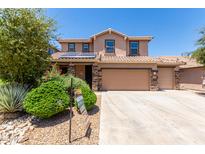 Two-story house with solar panels, three car garage, and landscaped front yard at 4506 W Maggie Dr, San Tan Valley, AZ 85144