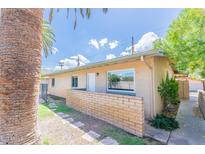 Ranch style home with a brick facade and walkway at 4943 E Indian School Rd # 4, Phoenix, AZ 85018