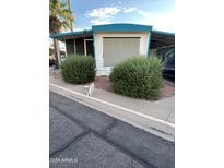 Mobile home with carport and landscaping at 2460 E Main St # G3, Mesa, AZ 85213
