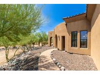Charming home with stone pathway and desert landscaping at 16738 E Lone Mountain Rd, Scottsdale, AZ 85262