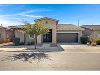 Single-story home with a two-car garage and a landscaped front yard at 22443 E Munoz St, Queen Creek, AZ 85142