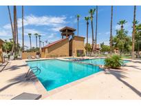 Community pool with surrounding lounge chairs at 4901 S Calle Los Cerros Dr # 267, Tempe, AZ 85282