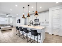 Open concept kitchen with island, stainless steel appliances, and living area view at 2216 E Meadowview Ct, Gilbert, AZ 85298