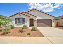 Single-story home with brown garage door and landscaping at 1142 E Atwood Dr, Casa Grande, AZ 85122