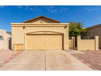 Front exterior view of a single-story house with a two-car garage and a neat front yard at 4148 E Camino St, Mesa, AZ 85205