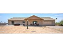 Single story home with covered patio, hot tub, and mature cactus at 5095 N Grand Dr, Apache Junction, AZ 85120