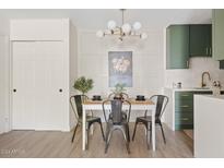 Bright dining area with a modern kitchen and stylish light fixture at 7350 N Via Paseo Del Sur -- # P202, Scottsdale, AZ 85258